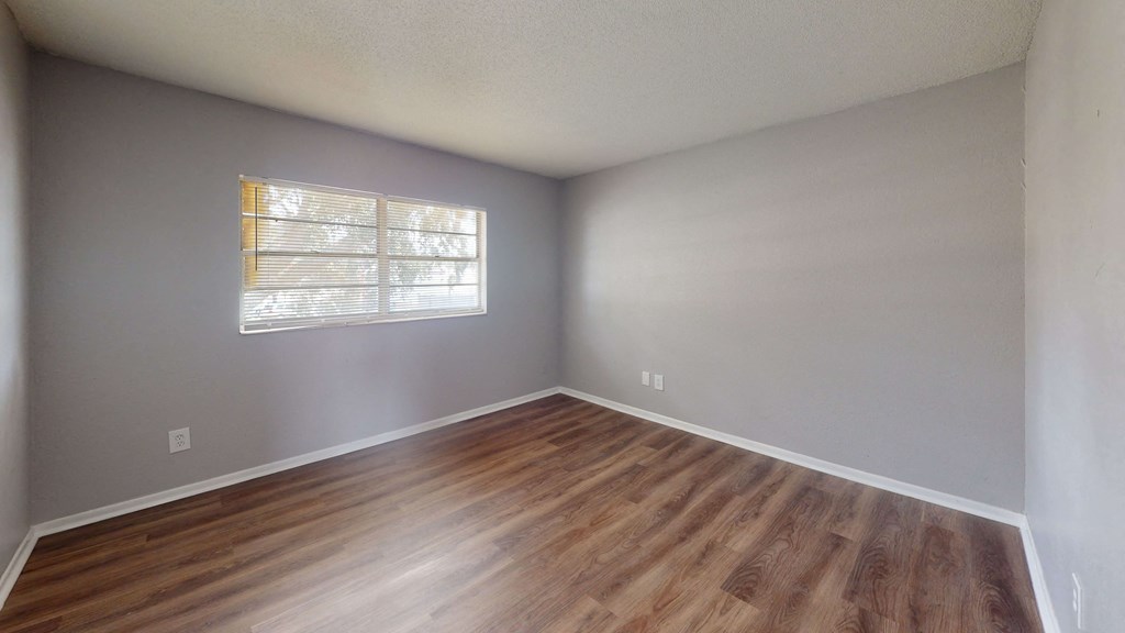 a dining room with hardwood floors and white walls