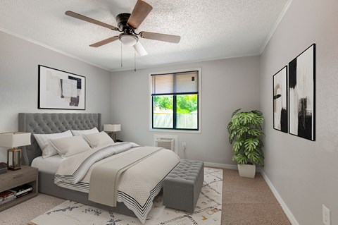 a bedroom with a ceiling fan and a plant