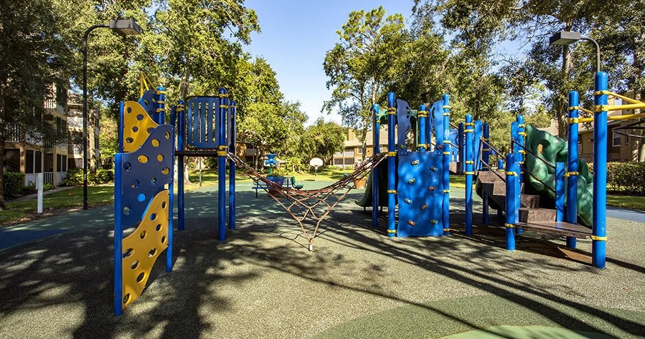 A playground with blue and yellow equipment.