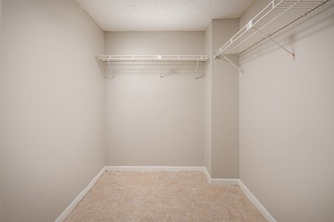 an empty bedroom with a large closet with a hanging rack on the wall at Fairways of Inverrary, Florida, 33319