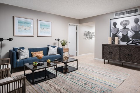 an open living room with a blue couch and a coffee table at Fairways of Inverrary, Florida