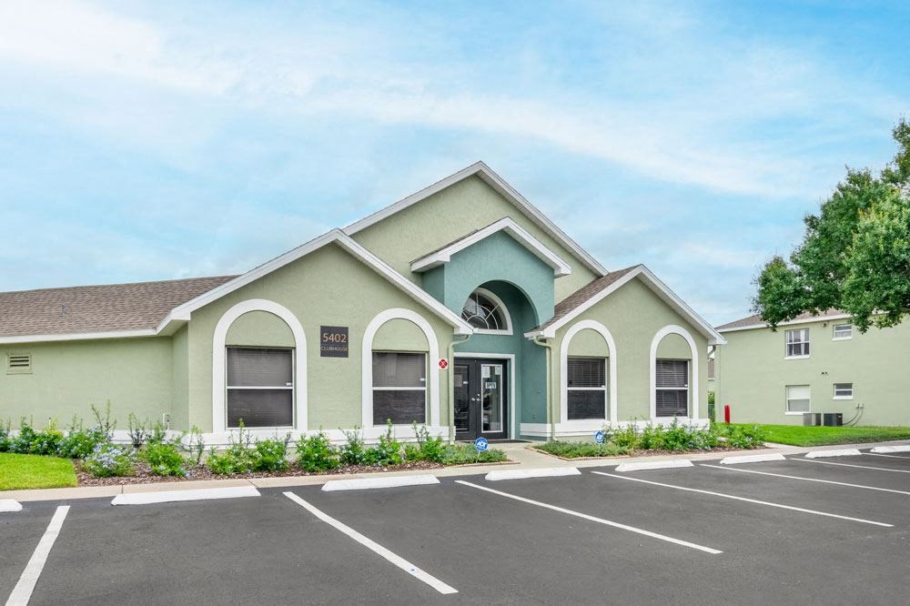 Clubhouse exterior with parking lot_Rolling Hills Apartments
