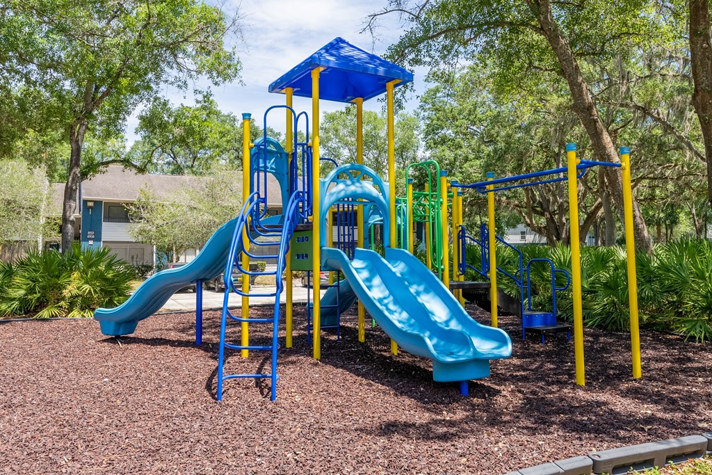 a playground with a blue and yellow play set  at Fisherman's Landing Apartment Homes, Tampa, FL
