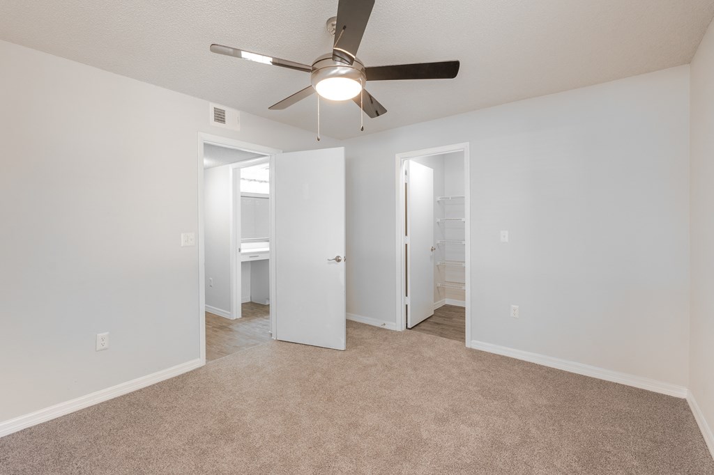 an empty living room with a ceiling fan and a closet  at Fisherman's Landing Apartment Homes, Tampa, 33637