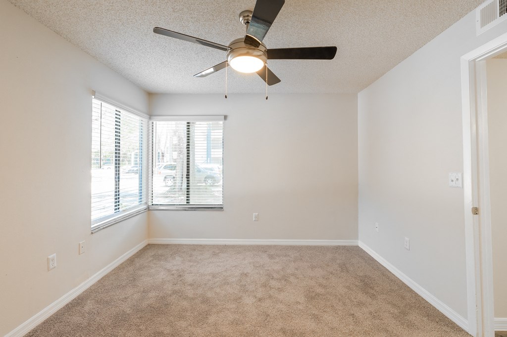 an empty living room with a ceiling fan and a window  at Fisherman's Landing Apartment Homes, Tampa, 33637