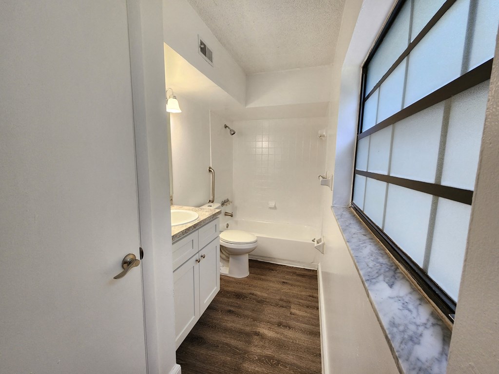 an empty bathroom with a toilet and a sink at Greenwich Commons Apartment Homes, Tampa