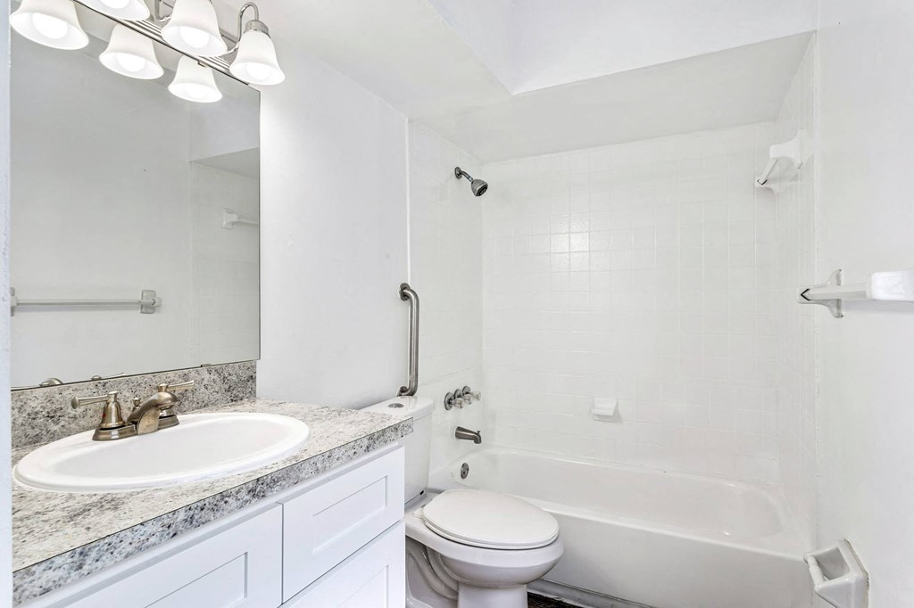 a bathroom with a sink toilet and a bath tub at Greenwich Commons Apartment Homes, Tampa