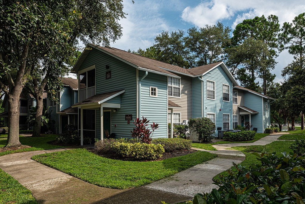 a blue house with a sidewalk in front of it at Madison Oaks Apartment Homes, LLC, Florida, 34684