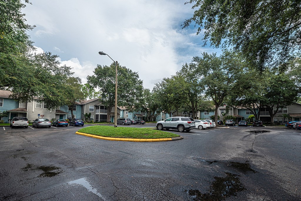 a city street with cars parked in front of houses at Madison Oaks Apartment Homes, LLC, Palm Harbor, FL