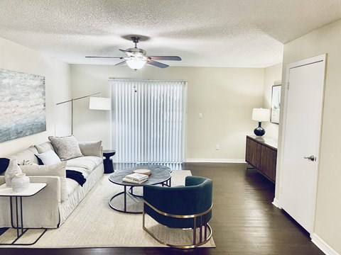 a living room with a couch and a ceiling fan