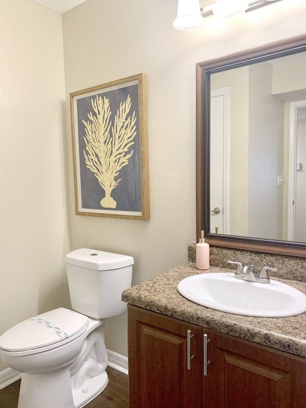 a bathroom with a sink toilet and a mirror at Madison Oaks Apartment Homes, LLC, Palm Harbor, FL 34684