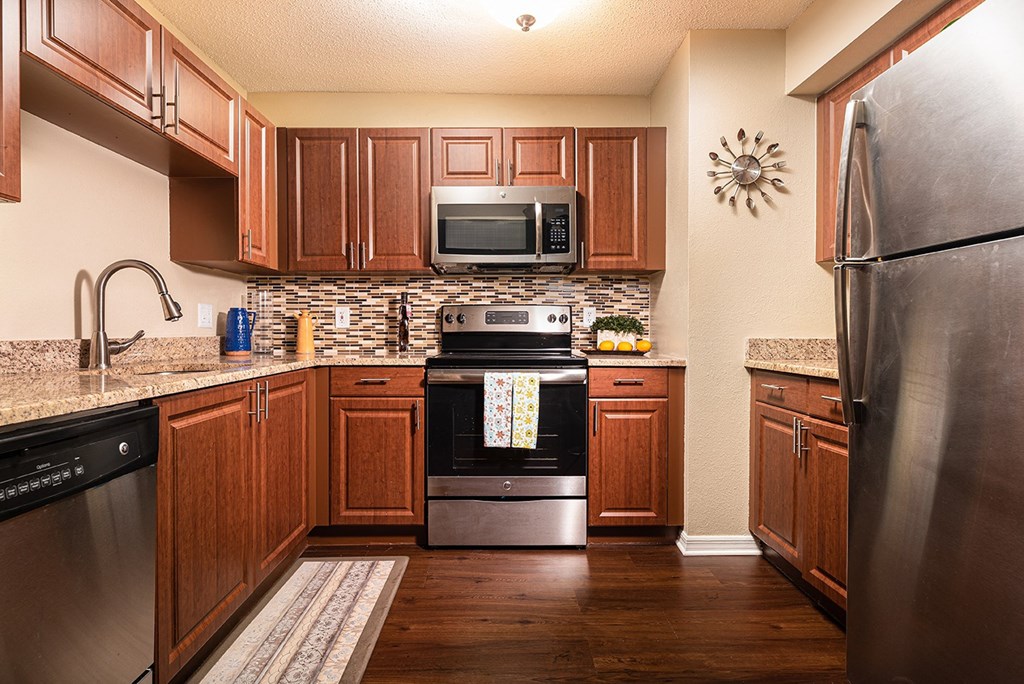 full kitchen with stainless steel appliances and wooden cabinets at Madison Oaks Apartment Homes, LLC, Palm Harbor, FL