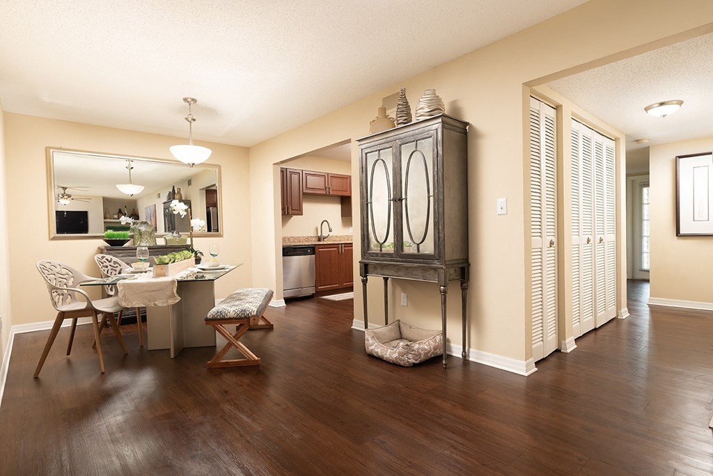 the view of a living room and dining room with a table and chairs at Madison Oaks Apartment Homes, LLC, Palm Harbor
