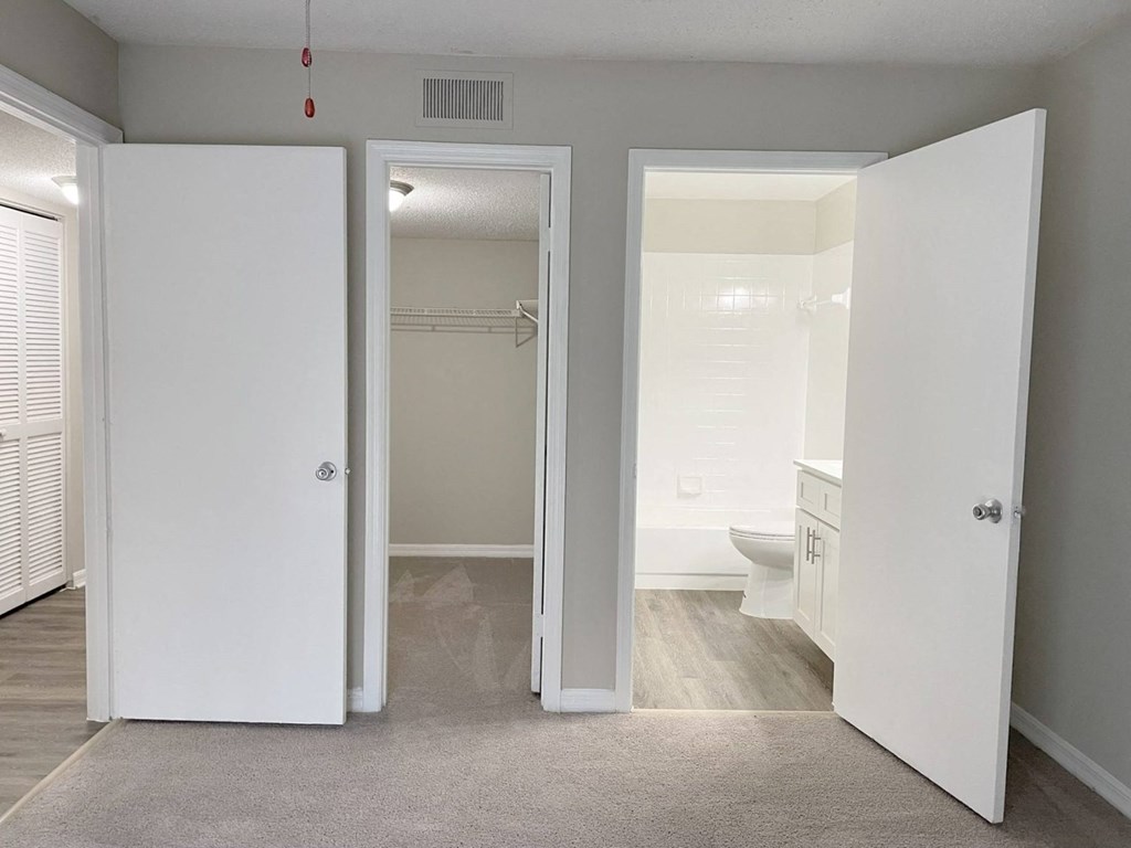 a bedroom with a bathroom and a closet at Madison Oaks Apartment Homes, LLC, Palm Harbor, 34684