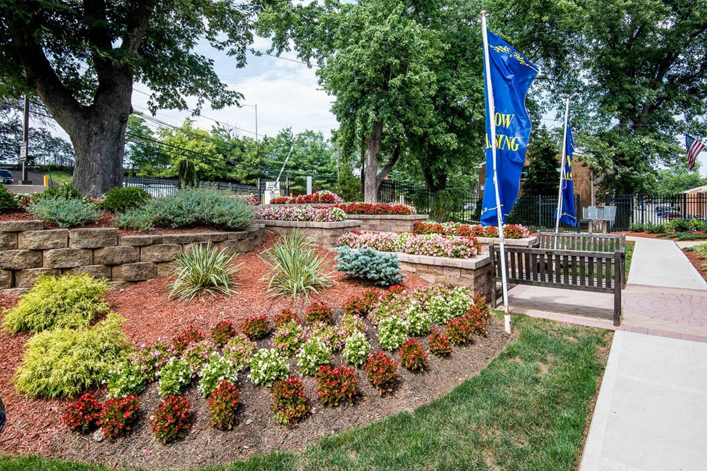 a park with a bench and a flower garden at Raritan Crossing Apartment Homes, New Brunswick New Jersey