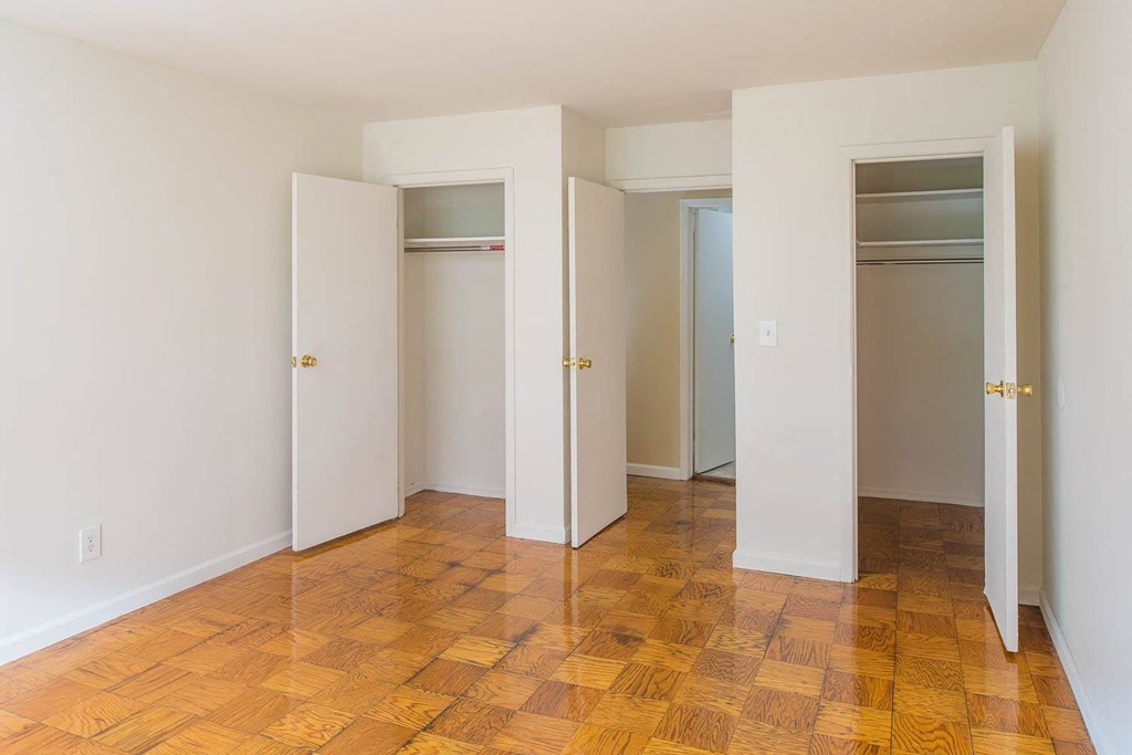 a empty room with four closets and a wooden floor at Raritan Crossing Apartment Homes, New Brunswick