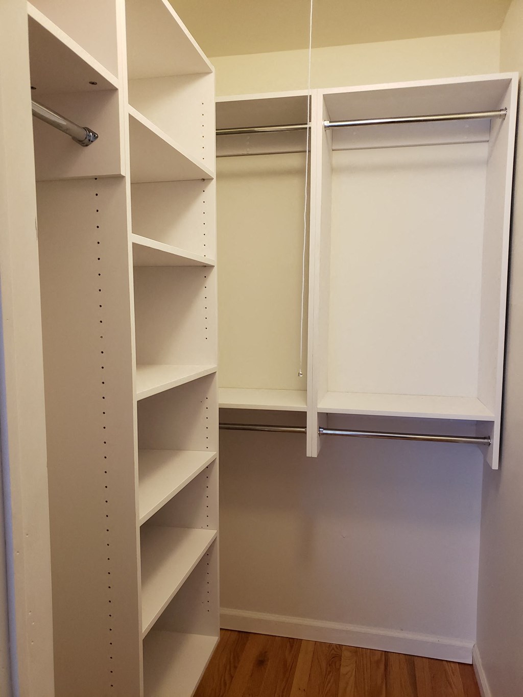 a walk in closet with white shelves and at Raritan Crossing Apartment Homes, New Brunswick, NJ 