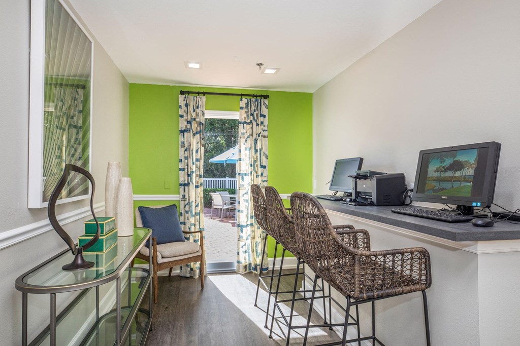 a living room with a desk and a computer