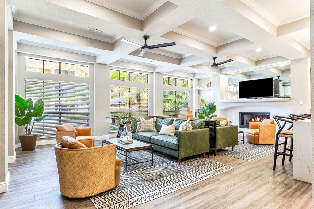 a living room with couches and chairs and a fireplace at Hidden Palms Apartment Homes, Tampa, Florida