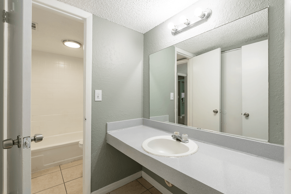 a bathroom with a sink and a bathtub at Bella Mar Apartments