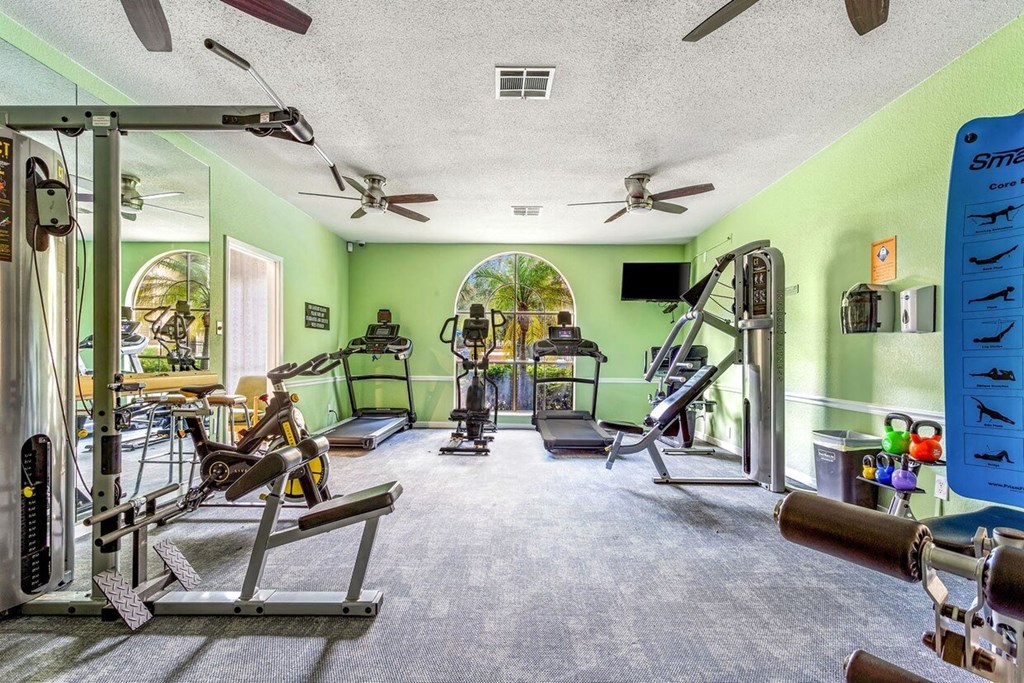 A well equipped gym with a variety of exercise equipment.