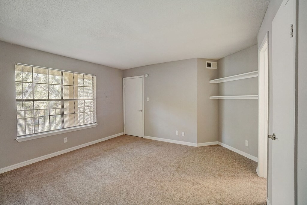 A room with a window and a door.