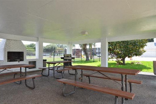 A covered picnic area with tables and benches.
