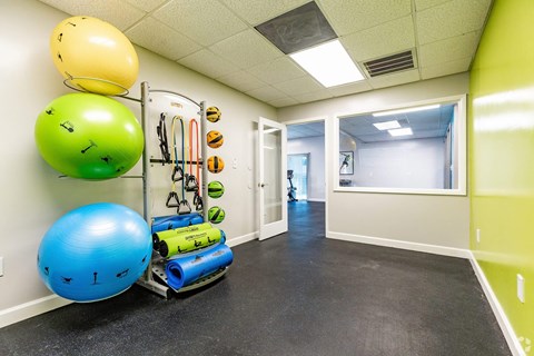 a workout room with weights and other exercise equipment on the wall