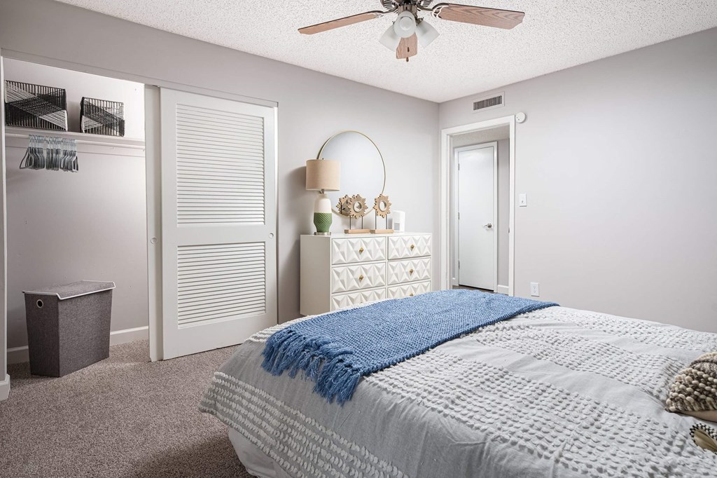 a bedroom with a bed and a ceiling fan  at The Park at Chesterfield Apartment Homes, Tampa