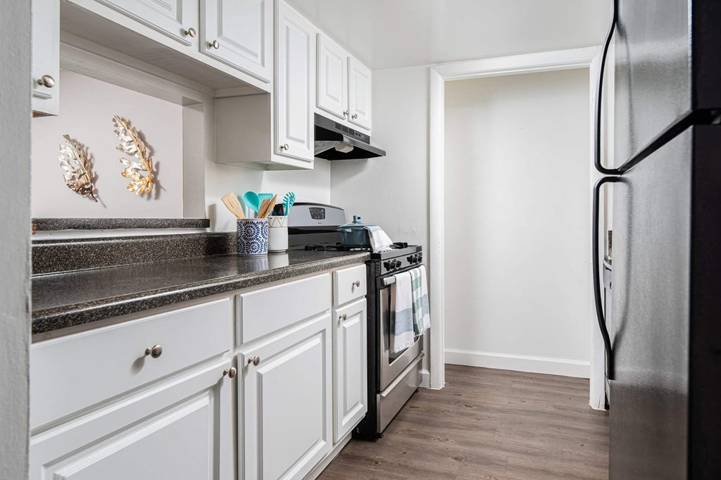 a kitchen with white cabinets and stainless steel appliances  at The Park at Chesterfield Apartment Homes, Florida, 33617