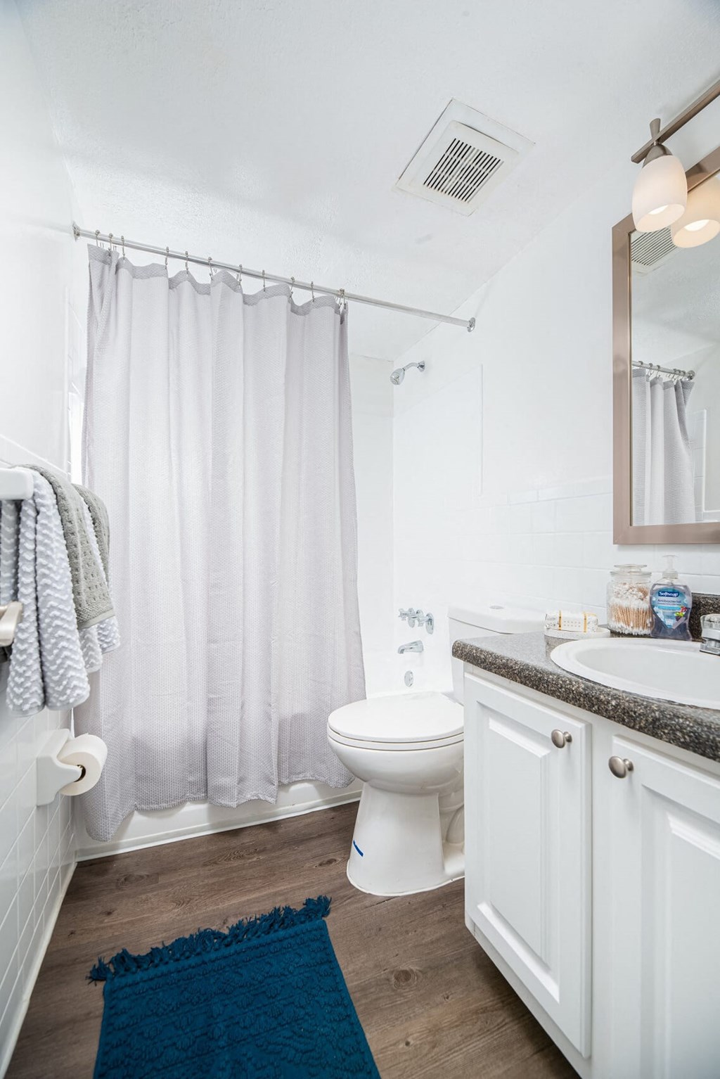 a white bathroom with a shower and a toilet  at The Park at Chesterfield Apartment Homes, Tampa
