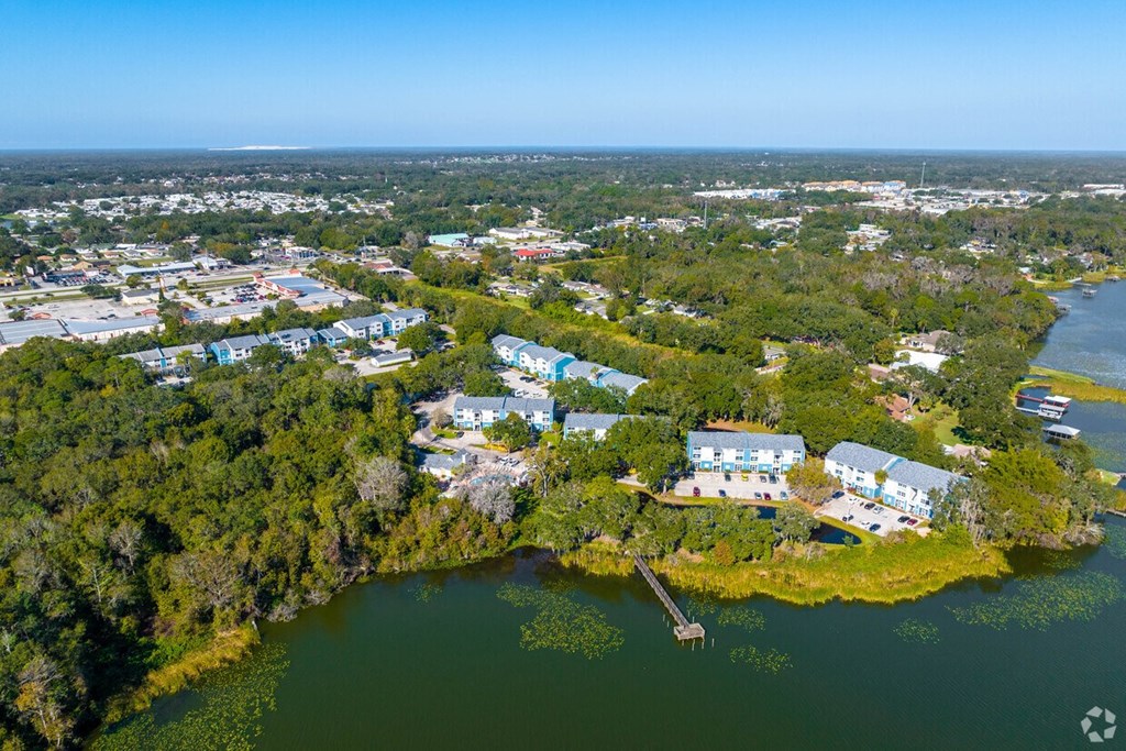 A small island with a few buildings surrounded by water.