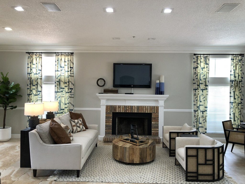 A living room with a fireplace and a television.
