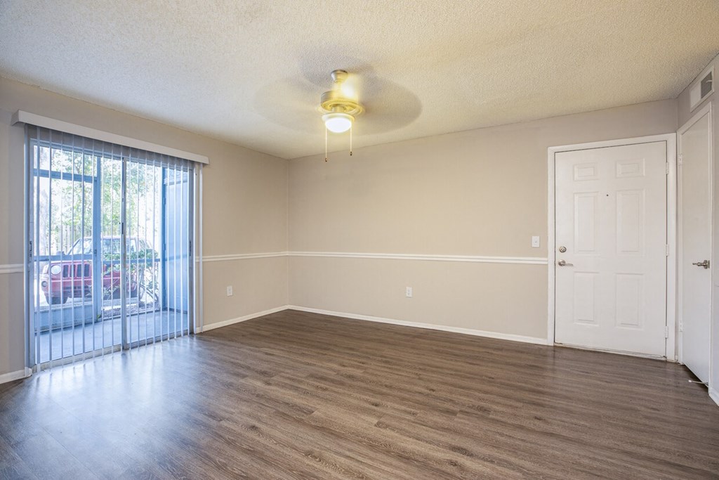 A room with a sliding glass door and a white door.