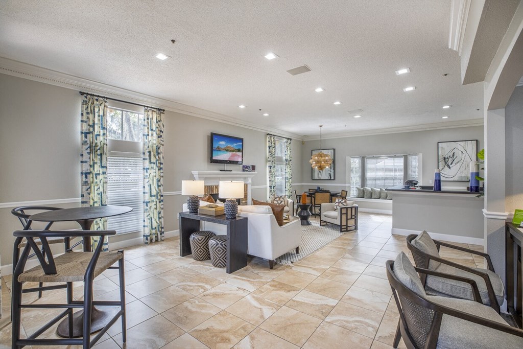 A well-lit living room with a dining table and chairs.