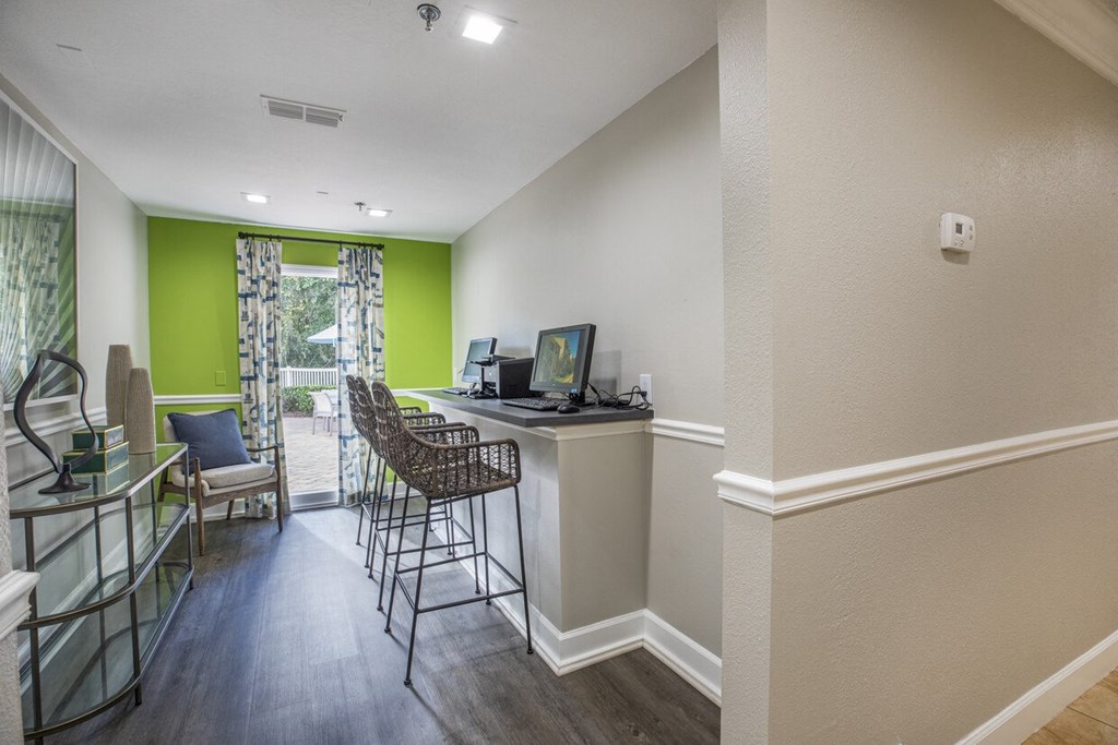 A room with a desk and chairs.