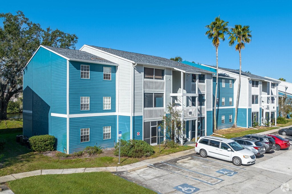A blue building with a white car parked in front.