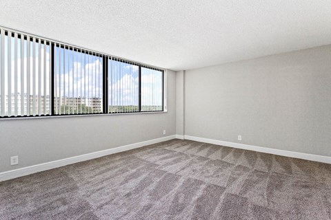 an empty living room with a large window at Fairways of Inverrary, Lauderhill, Florida