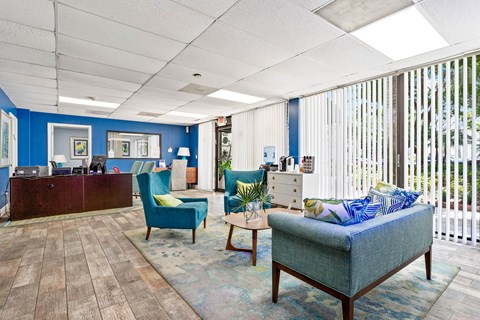 a lobby with couches and chairs and a reception desk at Fairways of Inverrary, Lauderhill, 33319