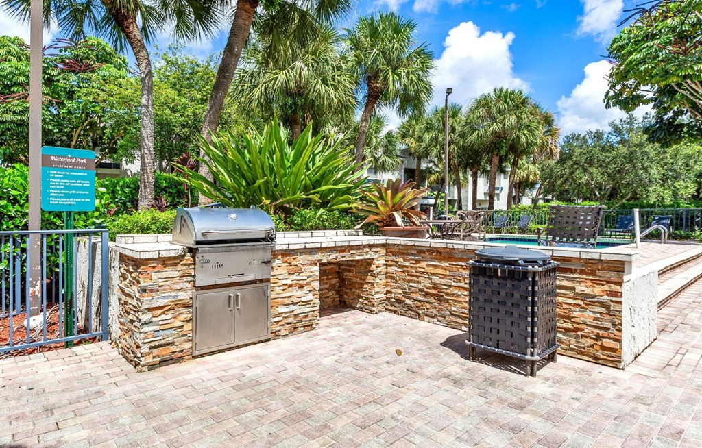 a brick patio with a barbecue grill and two stainless steel appliances at Waterford Park Apartment Homes, LLC, Florida, 33319