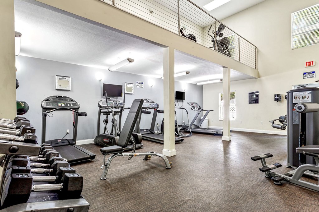 the gym has plenty of exercise equipment at the enclave at university heights apartments at Waterford Park Apartment Homes, LLC, Lauderhill