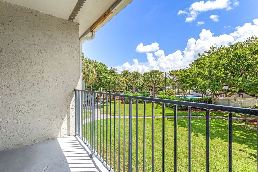 the view from the balcony of a house with a metal fence at Waterford Park Apartment Homes, LLC, Lauderhill, 33319