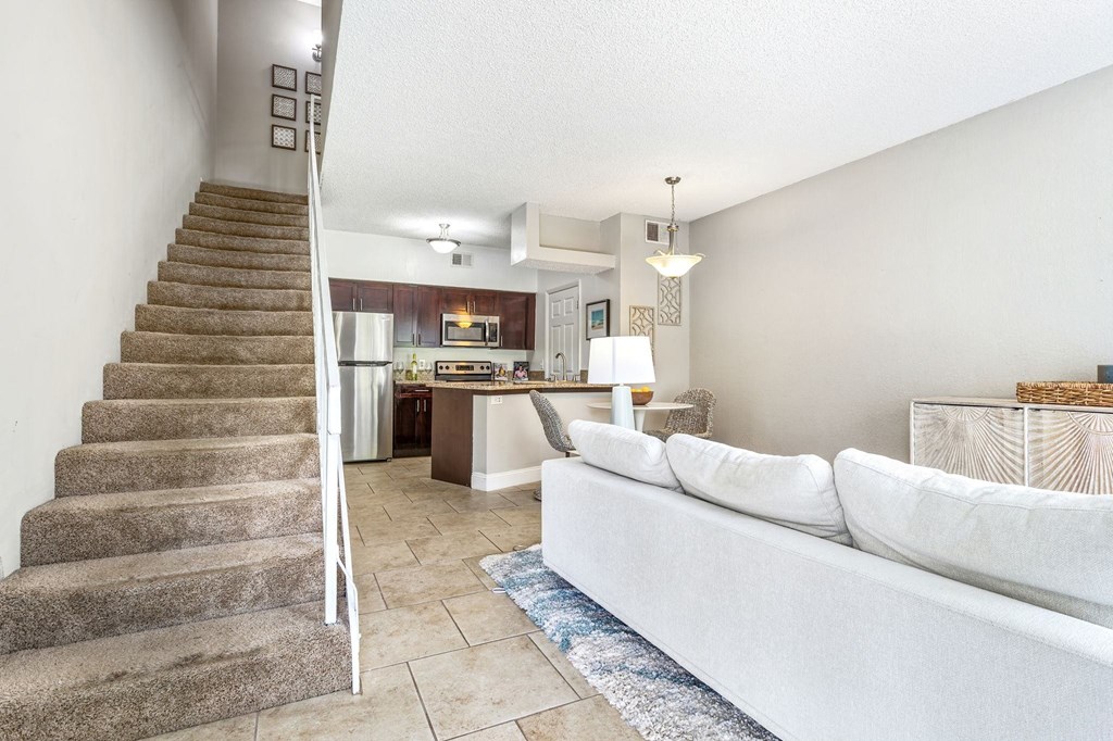 the living room and stairs leading to the kitchen and dining area at Waterford Park Apartment Homes, LLC, Lauderhill