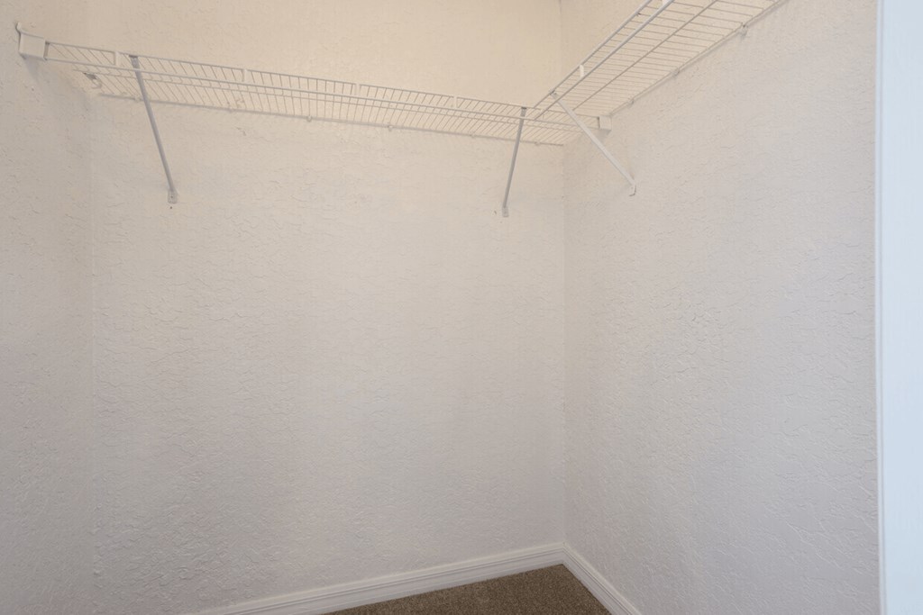A white wall with a metal rack on it.