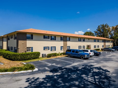 A building with a parking lot in front of it.