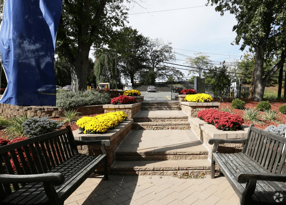 A park with benches and flower beds.