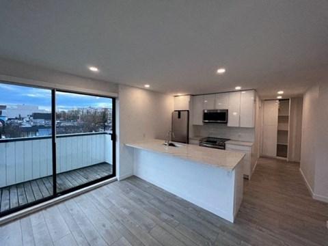 a kitchen and living room with a large window