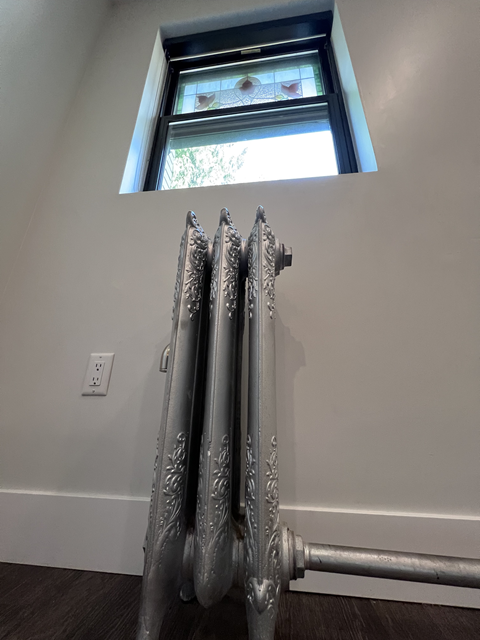 a radiator in a room with a skylight