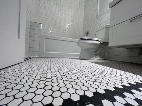 a white toilet sitting next to a bath tub