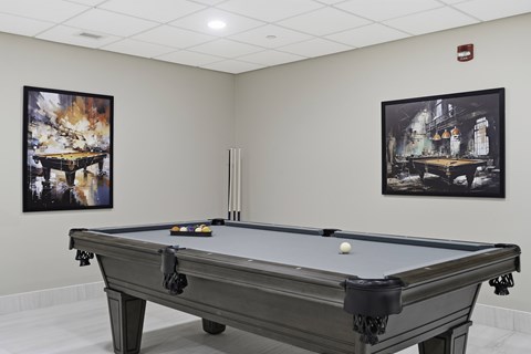A pool table with a white ball on it.